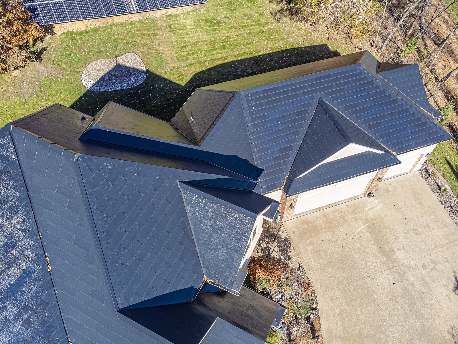 Overhead view of Tesla Solar Roof tiles covering entire home — drone photography