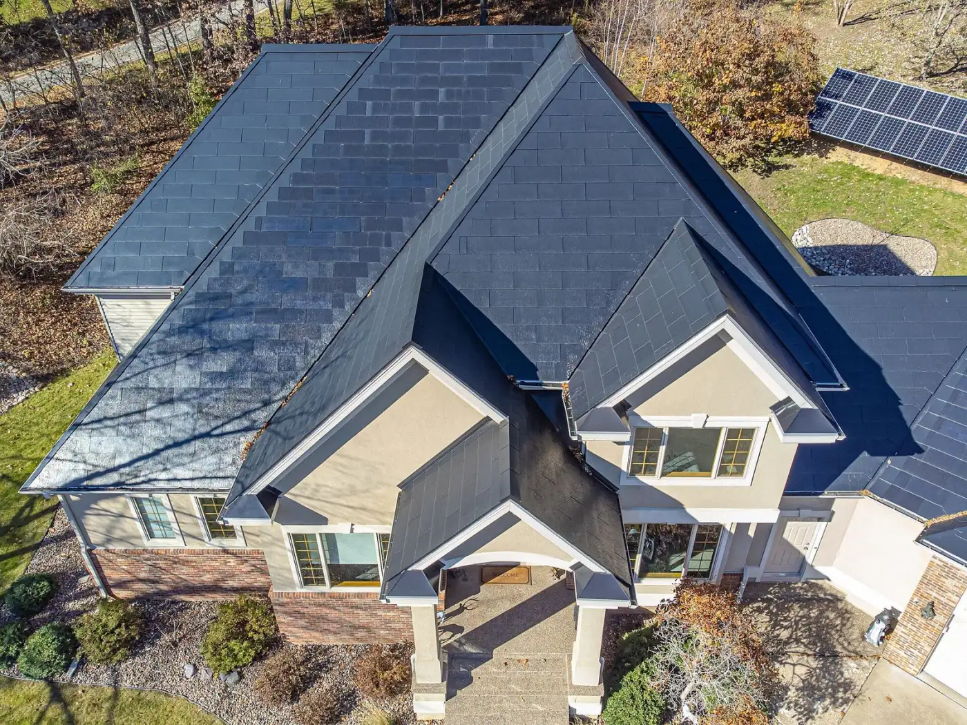 Front facade of home with Tesla Solar Roof — seamless glass shingle integration